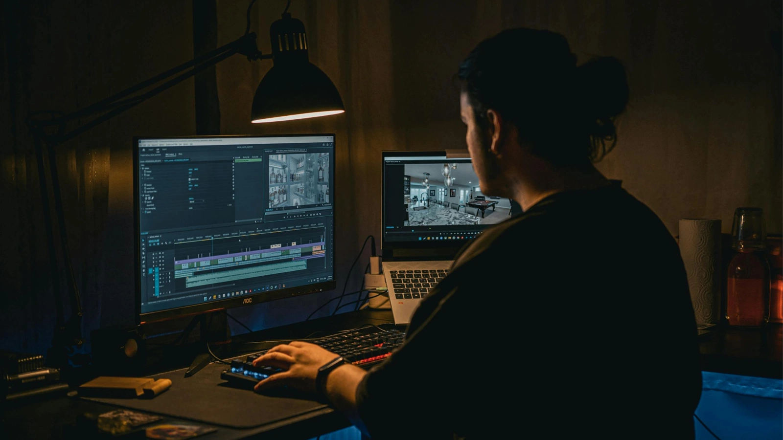 A person working on video production editing at a computer workstation.