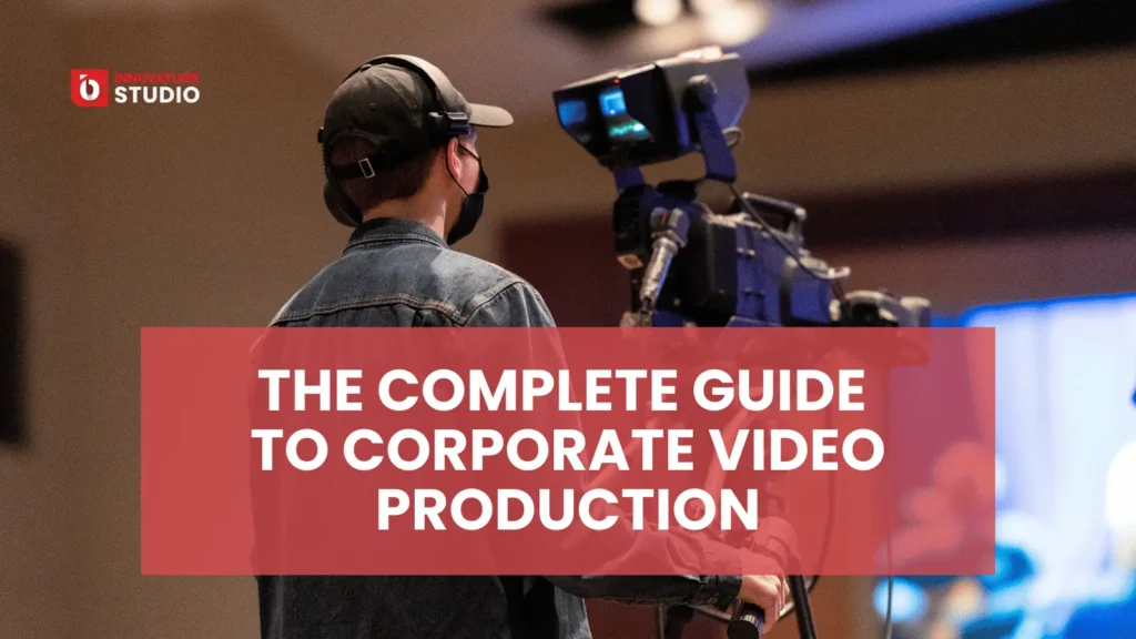 Behind-the-scenes of corporate video production with a director and camera crew filming an interview.